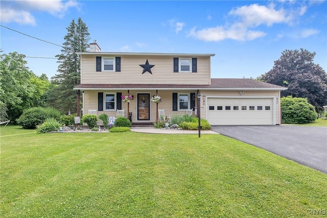 4956 Crestwood Ln, Onondaga, NY 13215 - traditional home featuring asphalt driveway, an attached garage, a front lawn, and a porch