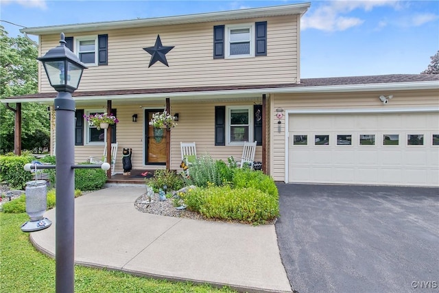 4956 Crestwood Ln, Onondaga, NY 13215 - traditional-style home featuring a porch, driveway, and an attached garage