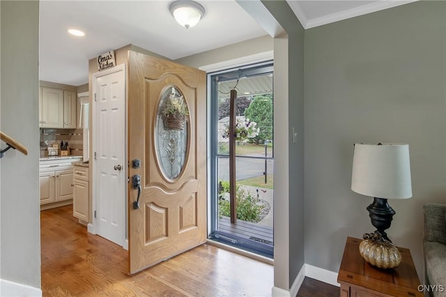 4956 Crestwood Ln, Onondaga, NY 13215 - entryway featuring light wood finished floors, crown molding, and recessed lighting