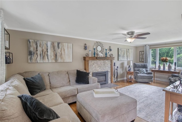 4956 Crestwood Ln, Onondaga, NY 13215 - living area with a tile fireplace, wood finished floors, a ceiling fan, and ornamental molding