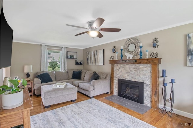 4956 Crestwood Ln, Onondaga, NY 13215 - living room featuring a ceiling fan, wood finished floors, crown molding, and a fireplace