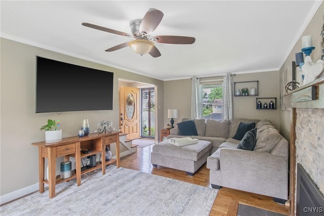 4956 Crestwood Ln, Onondaga, NY 13215 - living room featuring crown molding, ceiling fan, wood finished floors, and a fireplace