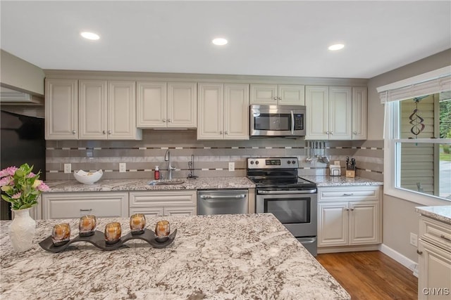 4956 Crestwood Ln, Onondaga, NY 13215 - kitchen with stainless steel appliances, decorative backsplash, wood finished floors, recessed lighting, and light stone countertops
