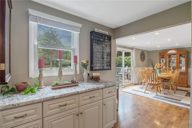4956 Crestwood Ln, Onondaga, NY 13215 - kitchen with light wood-style floors, light stone countertops, white cabinetry, and recessed lighting
