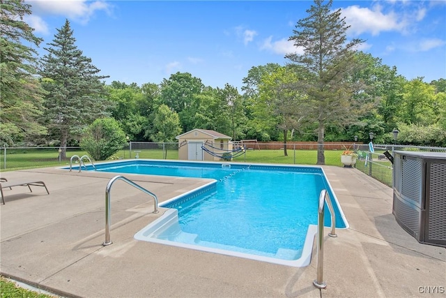 4956 Crestwood Ln, Onondaga, NY 13215 - view of swimming pool with a storage shed, a patio area, and view of scattered trees
