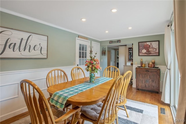 4956 Crestwood Ln, Onondaga, NY 13215 - dining area with light wood finished floors, crown molding, a wainscoted wall, and recessed lighting