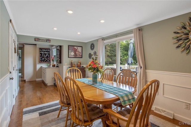 4956 Crestwood Ln, Onondaga, NY 13215 - dining room with crown molding, wainscoting, light wood-style floors, and recessed lighting