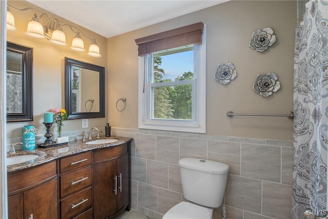 4956 Crestwood Ln, Onondaga, NY 13215 - bathroom with tile walls, double vanity, and wainscoting