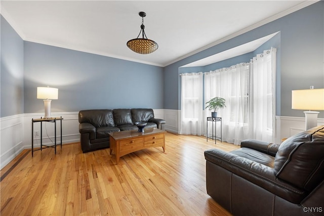 8067 Irish Mist Ln, Manlius, NY 13104 - living area featuring crown molding, wainscoting, light wood-style flooring, and a decorative wall