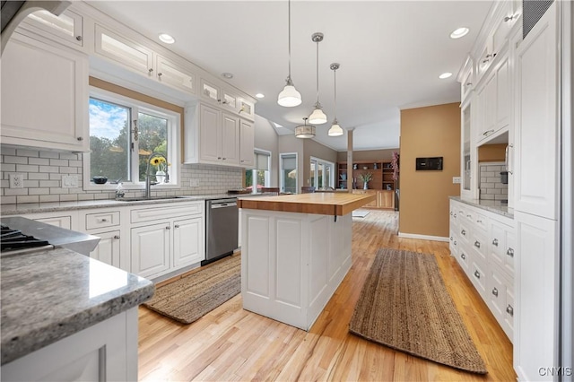 8067 Irish Mist Ln, Manlius, NY 13104 - kitchen with stainless steel dishwasher, wooden counters, light wood-style flooring, tasteful backsplash, and white cabinetry