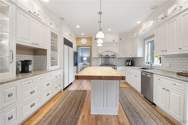 8067 Irish Mist Ln, Manlius, NY 13104 - kitchen with stainless steel dishwasher, wood counters, white cabinetry, tasteful backsplash, and light wood finished floors