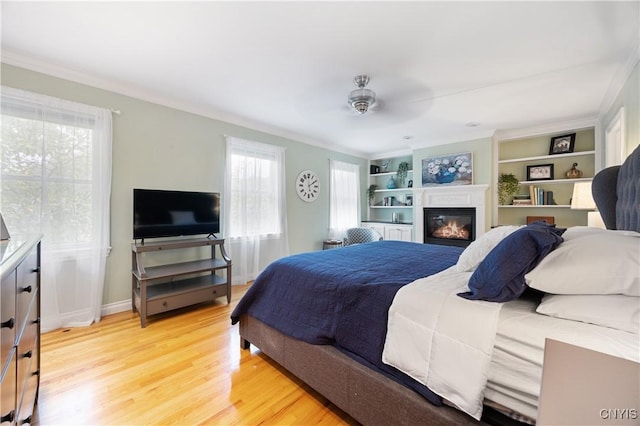 8067 Irish Mist Ln, Manlius, NY 13104 - bedroom featuring light wood-style floors and a glass covered fireplace