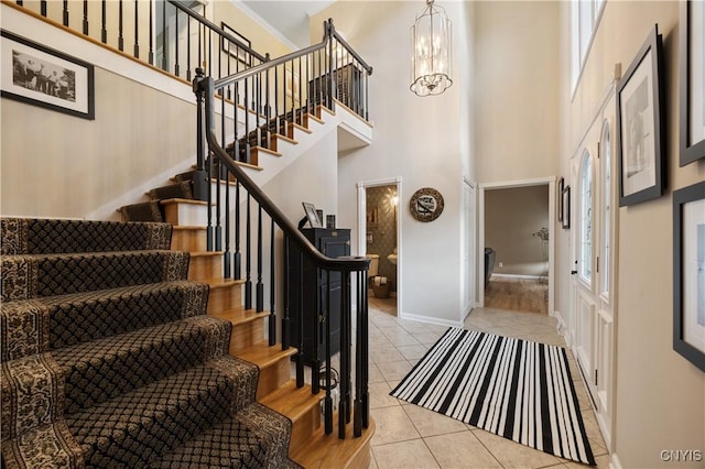 8067 Irish Mist Ln, Manlius, NY 13104 - entryway featuring stairway, light tile patterned flooring, a towering ceiling, and a chandelier