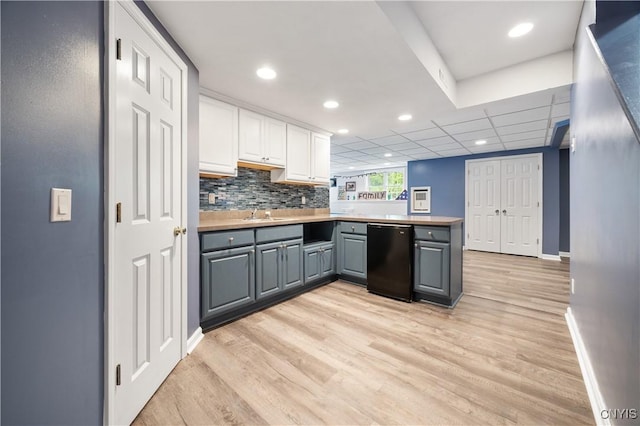 8067 Irish Mist Ln, Manlius, NY 13104 - kitchen with gray cabinets, light wood-style floors, white cabinets, a peninsula, and refrigerator