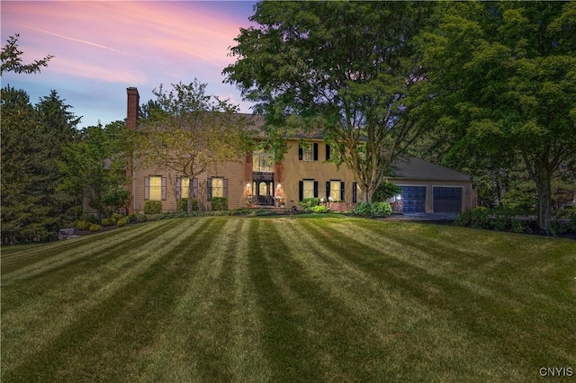 8067 Irish Mist Ln, Manlius, NY 13104 - colonial-style house featuring a yard, a chimney, a balcony, and a detached garage