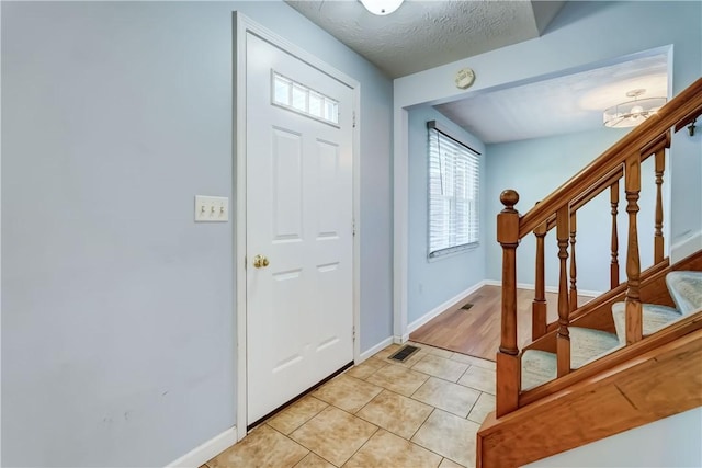 11 Hillcrest Dr, Hamlin, NY 14464 - foyer with light tile patterned floors and stairs