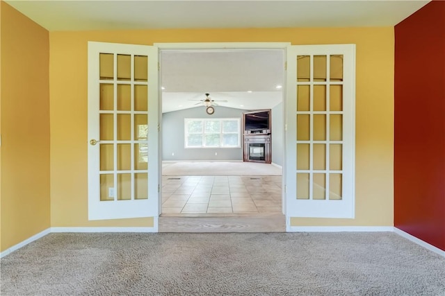 11 Hillcrest Dr, Hamlin, NY 14464 - spare room with vaulted ceiling, carpet, a ceiling fan, and a glass covered fireplace