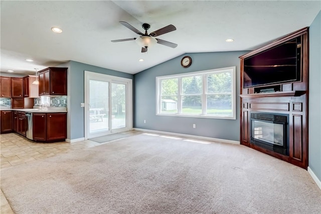 11 Hillcrest Dr, Hamlin, NY 14464 - unfurnished living room featuring a ceiling fan, light colored carpet, vaulted ceiling, a glass covered fireplace, and recessed lighting