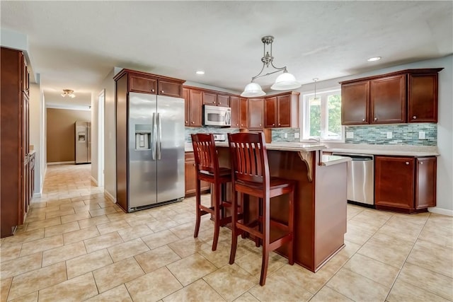 11 Hillcrest Dr, Hamlin, NY 14464 - kitchen featuring appliances with stainless steel finishes, light countertops, backsplash, a kitchen breakfast bar, and recessed lighting