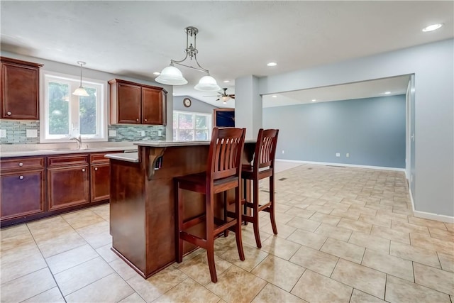 11 Hillcrest Dr, Hamlin, NY 14464 - kitchen featuring tasteful backsplash, light countertops, pendant lighting, a kitchen breakfast bar, and a ceiling fan