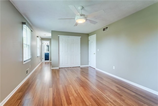 11 Hillcrest Dr, Hamlin, NY 14464 - unfurnished bedroom with light wood-style flooring, a closet, and a ceiling fan