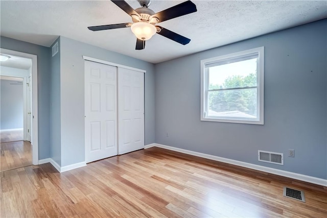 11 Hillcrest Dr, Hamlin, NY 14464 - unfurnished bedroom with light wood-style floors, a closet, and ceiling fan