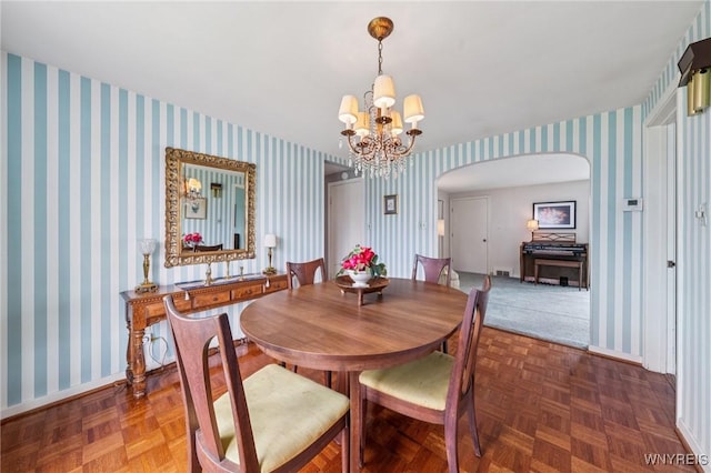 66 Gierlach St, Cheektowaga, NY 14212 - dining space with arched walkways, a chandelier, and wallpapered walls