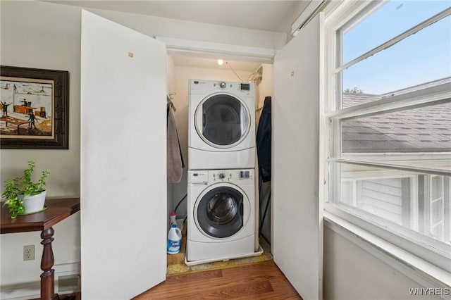 66 Gierlach St, Cheektowaga, NY 14212 - laundry area with stacked washing machine and dryer and wood finished floors