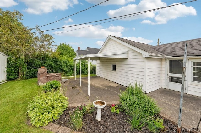 66 Gierlach St, Cheektowaga, NY 14212 - view of property exterior with a patio area, a yard, and a shingled roof