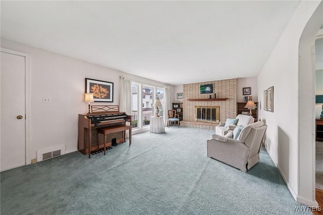 66 Gierlach St, Cheektowaga, NY 14212 - carpeted living area featuring arched walkways and a fireplace