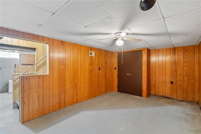 5539 Taormina Dr, Clay, NY 13041 - basement with wood walls, a paneled ceiling, and a ceiling fan