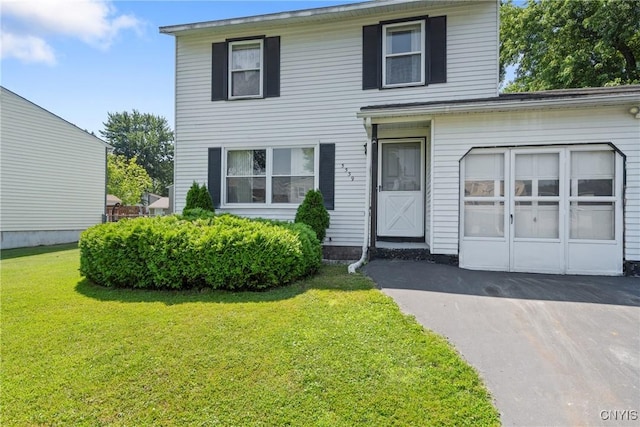 5539 Taormina Dr, Clay, NY 13041 - traditional-style house featuring a front lawn, driveway, and a garage