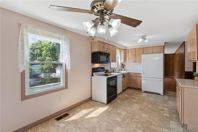5539 Taormina Dr, Clay, NY 13041 - kitchen with freestanding refrigerator, black microwave, electric stove, a ceiling fan, and light countertops