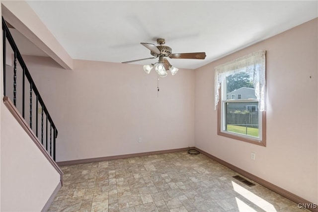 5539 Taormina Dr, Clay, NY 13041 - spare room featuring a ceiling fan, stairs, and stone finish flooring