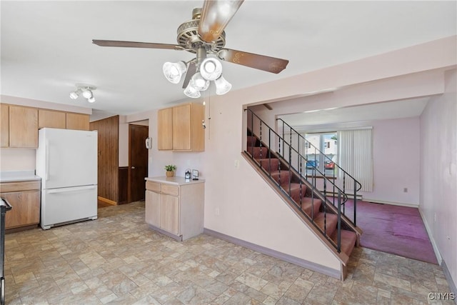 5539 Taormina Dr, Clay, NY 13041 - kitchen with freestanding refrigerator, stone finish floors, ceiling fan, light countertops, and light brown cabinets