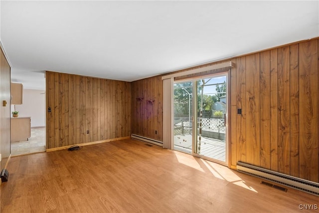 5539 Taormina Dr, Clay, NY 13041 - empty room with wood finished floors, wooden walls, and a baseboard radiator