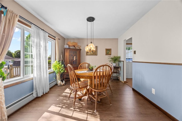 7980 Cedarwood Dr, Rome, NY 13440 - dining area with healthy amount of natural light, a baseboard radiator, and wood finished floors