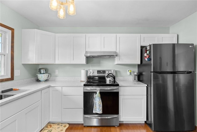 7980 Cedarwood Dr, Rome, NY 13440 - kitchen with appliances with stainless steel finishes, under cabinet range hood, light countertops, and white cabinetry