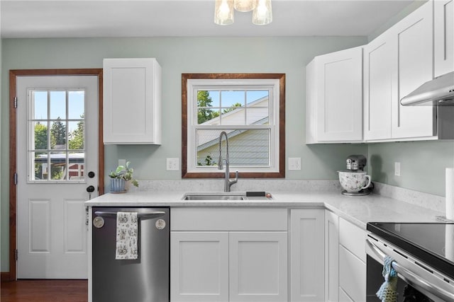 7980 Cedarwood Dr, Rome, NY 13440 - kitchen with appliances with stainless steel finishes, light countertops, white cabinets, and dark wood-type flooring