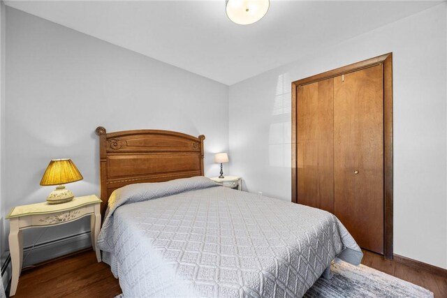 7980 Cedarwood Dr, Rome, NY 13440 - bedroom with a closet, wood finished floors, and baseboard heating