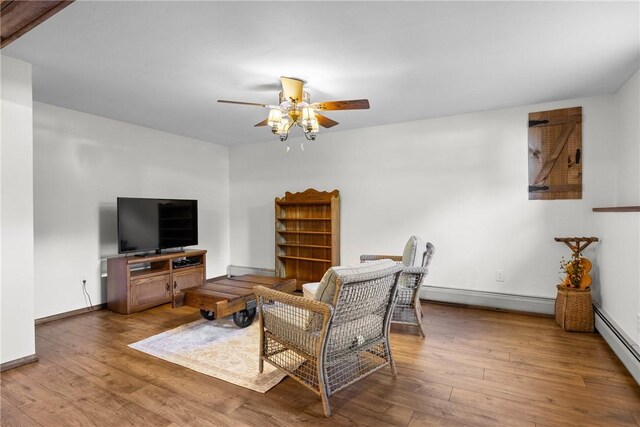 7980 Cedarwood Dr, Rome, NY 13440 - living area with a baseboard heating unit, ceiling fan, and wood finished floors