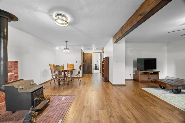 7980 Cedarwood Dr, Rome, NY 13440 - living area featuring a wood stove and wood finished floors