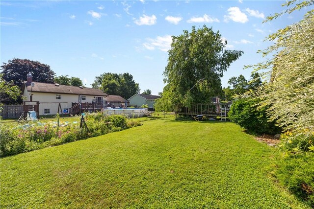 7980 Cedarwood Dr, Rome, NY 13440 - view of green lawn with a wooden deck
