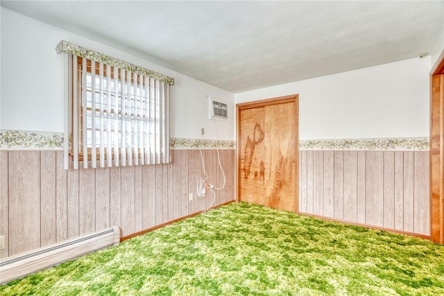 163 Auramar Dr, Irondequoit, NY 14609 - unfurnished room with a wainscoted wall, a baseboard radiator, wood walls, carpet, and an AC wall unit