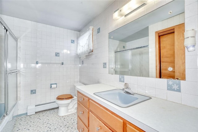 163 Auramar Dr, Irondequoit, NY 14609 - bathroom featuring baseboard heating, tile walls, a shower with shower door, vanity, and decorative backsplash