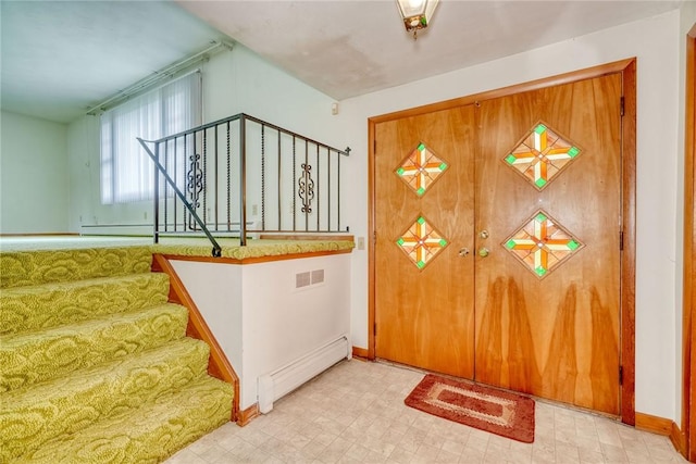163 Auramar Dr, Irondequoit, NY 14609 - foyer entrance with a baseboard radiator, tile patterned floors, and stairway