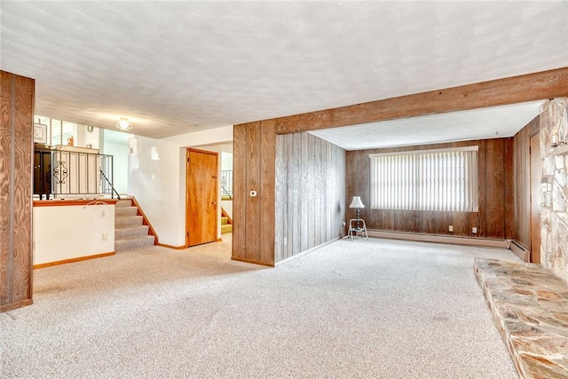 163 Auramar Dr, Irondequoit, NY 14609 - carpeted spare room featuring wooden walls, stairway, a baseboard heating unit, and a textured ceiling