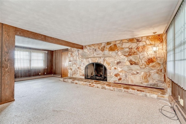163 Auramar Dr, Irondequoit, NY 14609 - unfurnished living room featuring a baseboard heating unit, carpet, wooden walls, and a stone fireplace