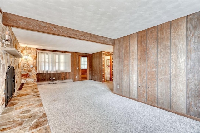 163 Auramar Dr, Irondequoit, NY 14609 - unfurnished living room with wooden walls, a stone fireplace, baseboard heating, a textured ceiling, and beamed ceiling