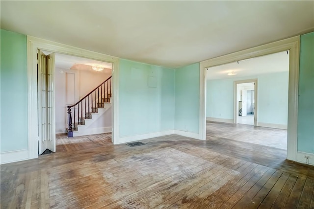 1621 Bragg St, Lima, NY 14485 - unfurnished room with hardwood / wood-style floors, stairway, and a chandelier